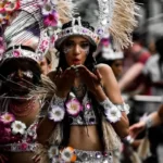 A woman in cultural dress blowing a kiss