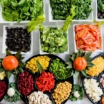a wide and colourful variety of fruit and veg on plates