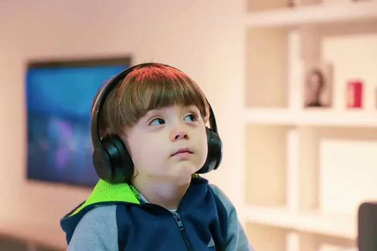 A disabled child wearing headphones looking thoughtful