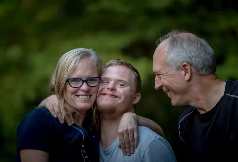 A young man with downs syndrome and his parental carers