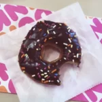 a chocolate donut with a bite taken out