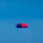a blue and red pill against a blue background