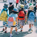 A group of children walking to school on a sunny day