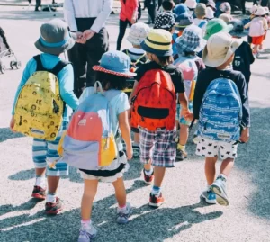 A group of children walking to school on a sunny day
