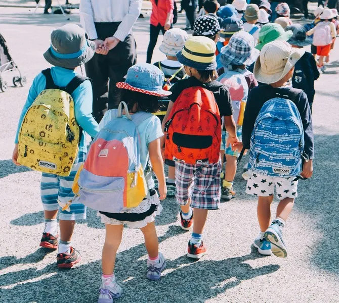 A group of children walking to school on a sunny day