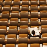 A single student sat in a lecture hall - neoliberal effect on education