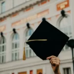 a person holding a university mortar board