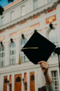 a person holding a university mortar board