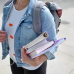 A student carrying education materials