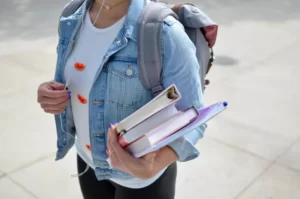 A student carrying education materials