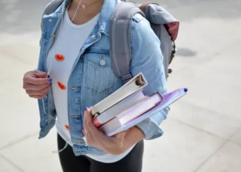 A student carrying education materials