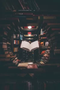 a floating book in the middle of more education books