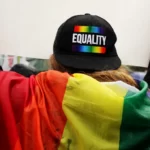 a person wearing a cap that says equality
