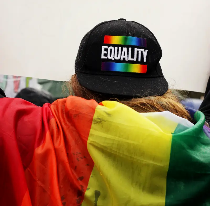 a person wearing a cap that says equality