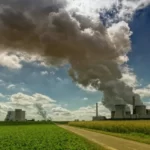 A power plant pumping out smoke on a sunny day