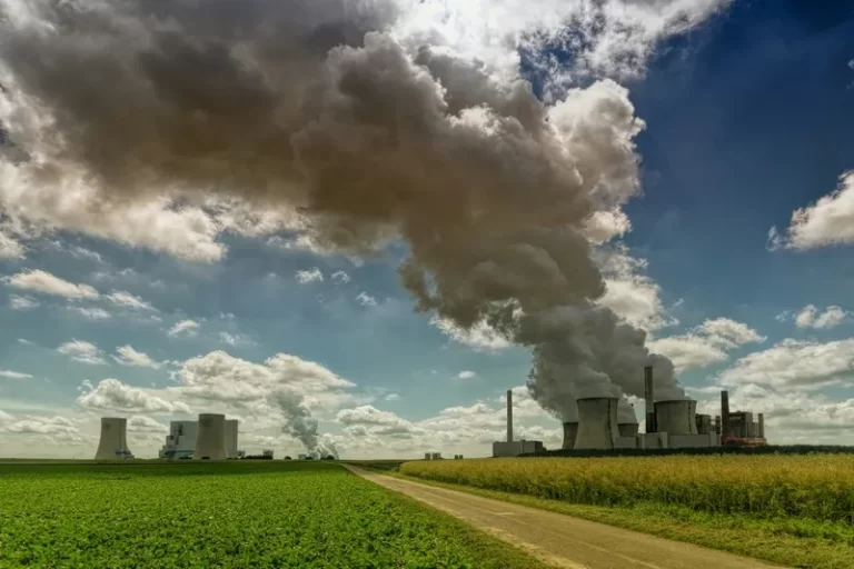 A power plant pumping out smoke on a sunny day