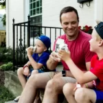 A father and two sons all having a pint of milk each