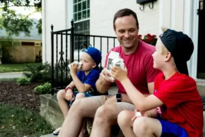 A father and two sons all having a pint of milk each