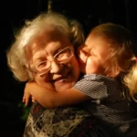 A grandma duddling her granddaughter