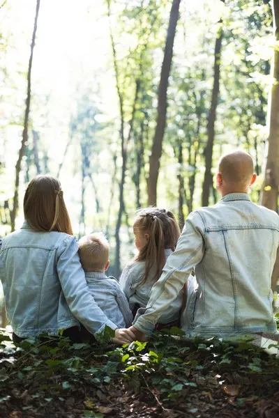 A family of four in the forest