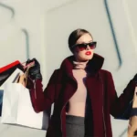 A rich woman carrying bags of shopping - bourgeoisie
