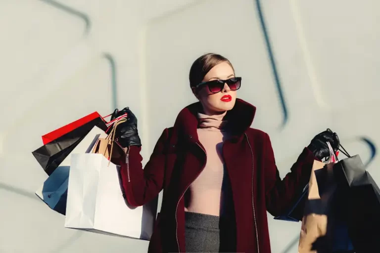 A rich woman carrying bags of shopping - bourgeoisie