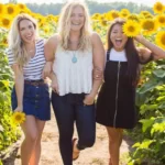A group of three females on a sunny day