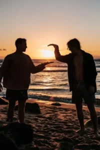two guys high fiving at sunset