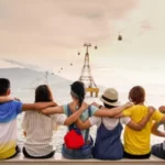 A group of people vied from behind and sat at the shoreline with a collective conscience