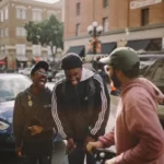 three black friends laughing in the street