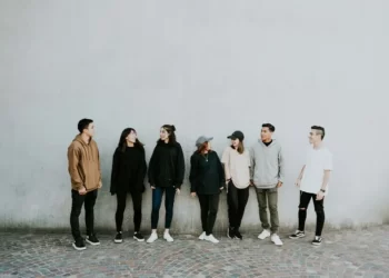 A group involved in community safety standing against a wall