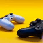 two playstation controllers against a yellow background