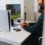 A gamer playing ps5 with a monitor