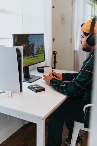 A gamer playing ps5 with a monitor
