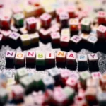 some colourful square beads which denote the gender 'non-binary'