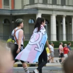 A person draped in a LGBTQ flag - gender as a social construct