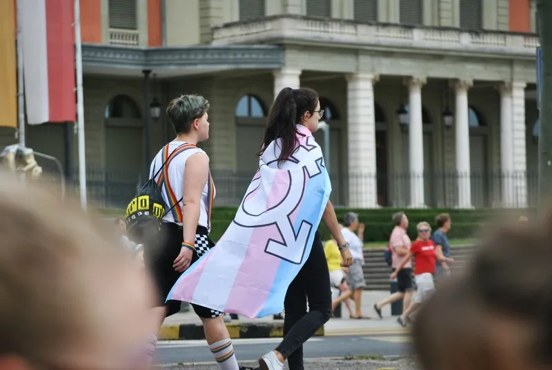 A person draped in a LGBTQ flag - gender as a social construct
