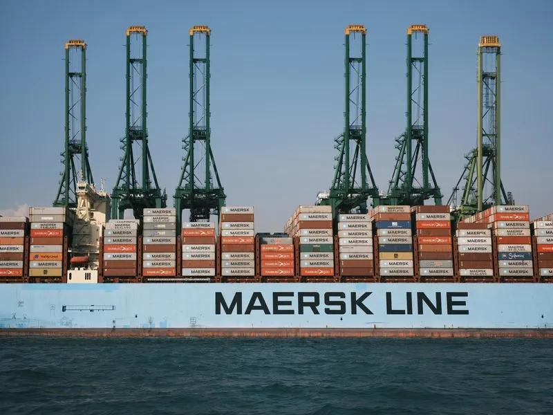 A container ship transporting containers with the name 'maersk line' on the side