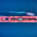 A container ship[ and tug boat viewed from above - globalisation