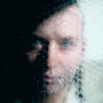 a person hiding back stage behind bubble wrap