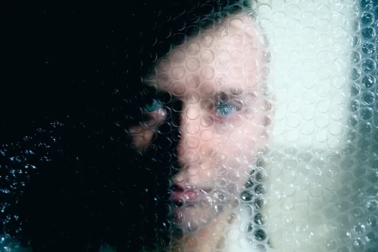 a person hiding back stage behind bubble wrap