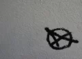 An anarchist symbol written in black on a white background