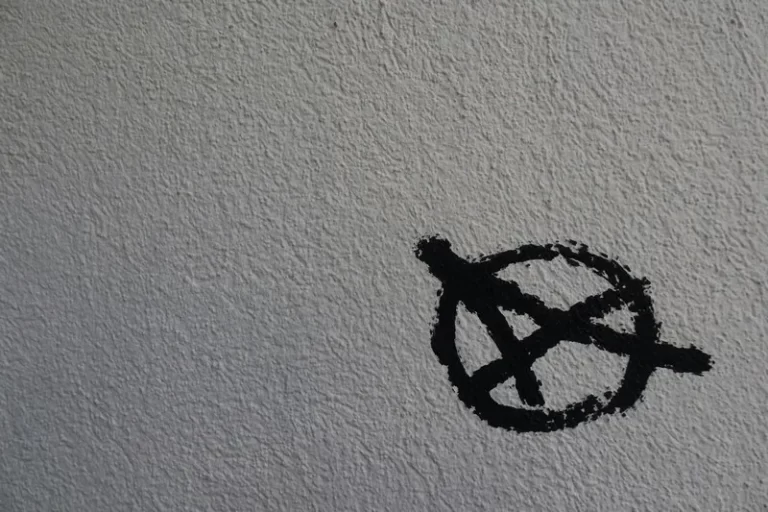 An anarchist symbol written in black on a white background