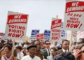 Protestors holding placards sdemanding the right to vote in democracy