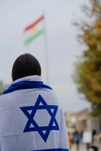 A person draped in the Israeli zionist star of david flag