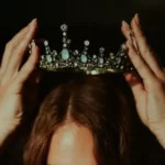 A woman adorning a crown - ascribed status