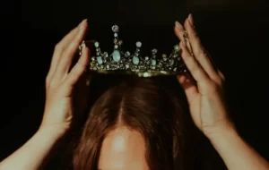 A woman adorning a crown - ascribed status