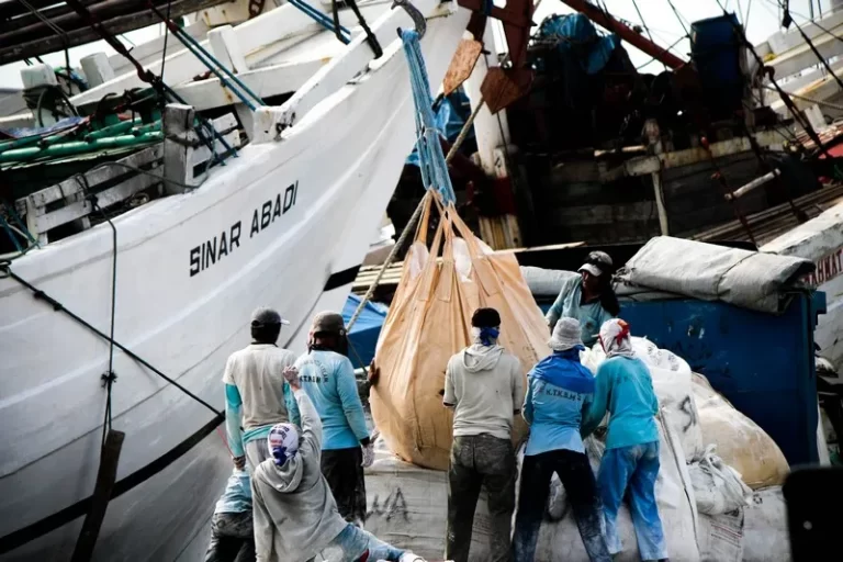 A group of men working in shipping