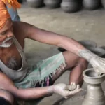 A man making pottery in the street