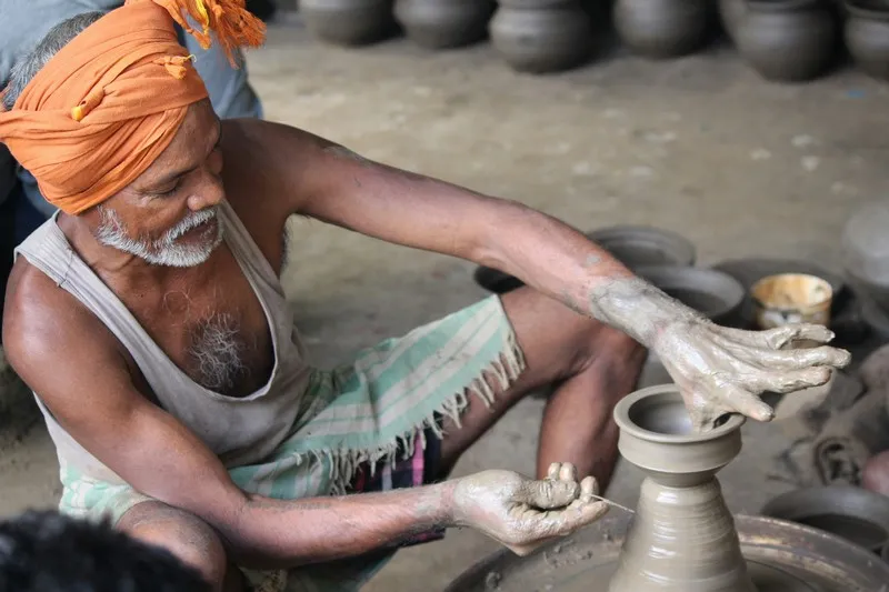 A man making pottery in the street